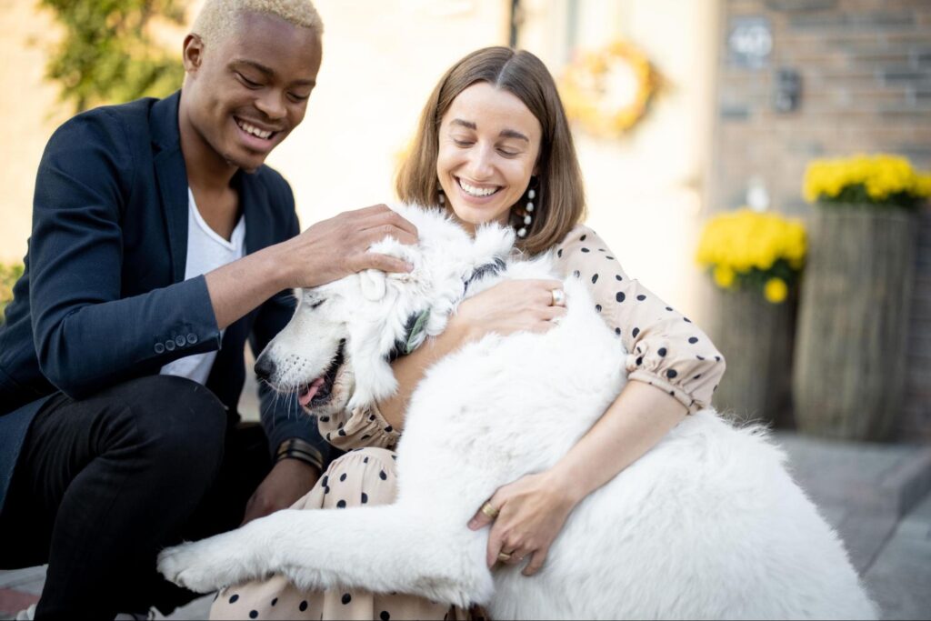 a man and woman happy holding a dog that they diagnosed with the first signs of cushing's disease